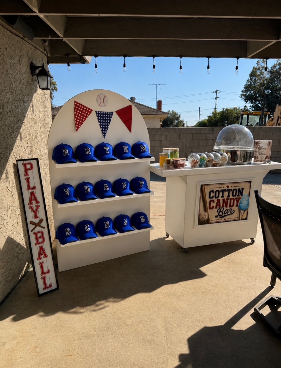 Baseball-themed personalized favor display with custom letter hats and cotton candy bar setup