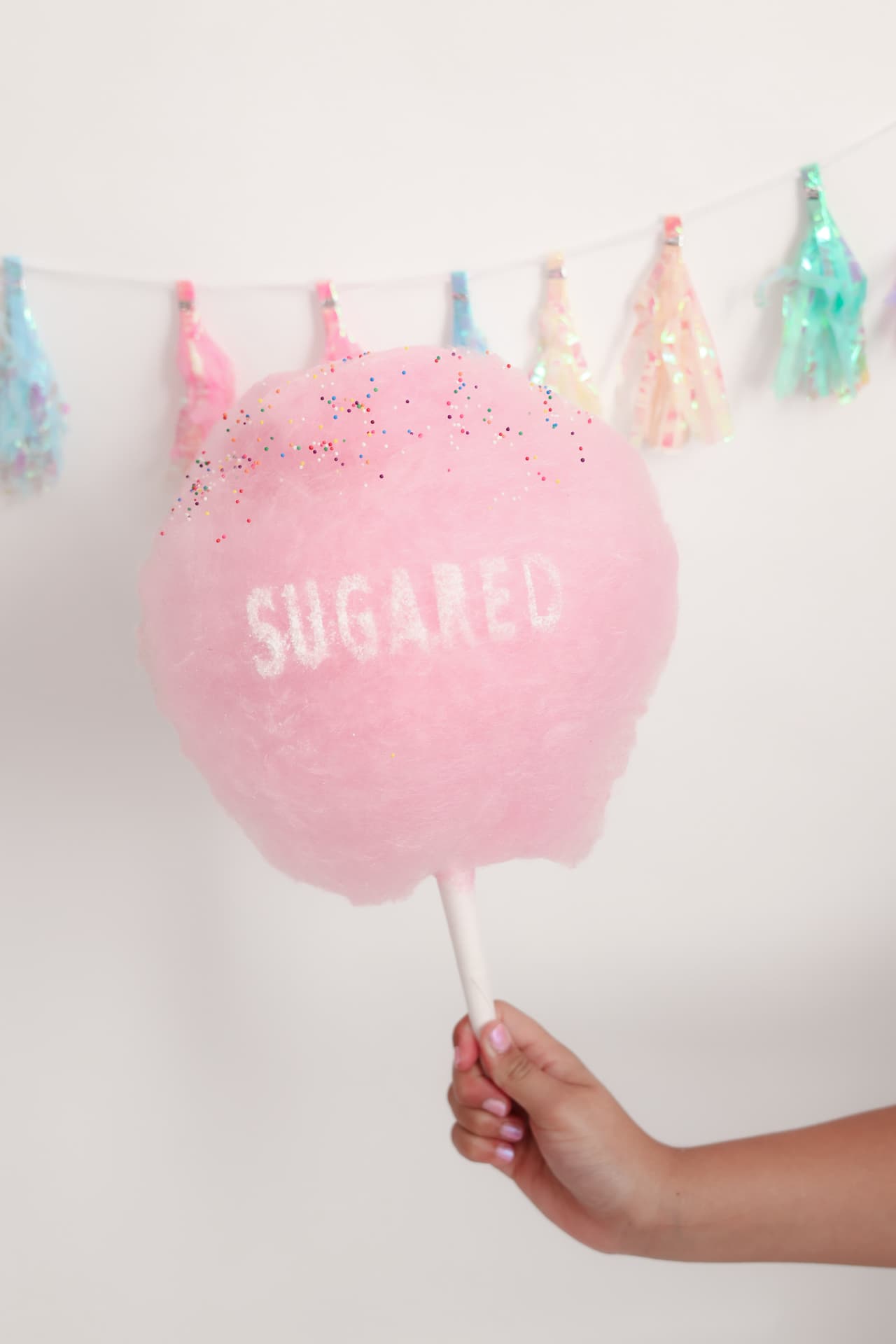 Pink cotton candy puff with SUGARED stamped on top and sprinkles