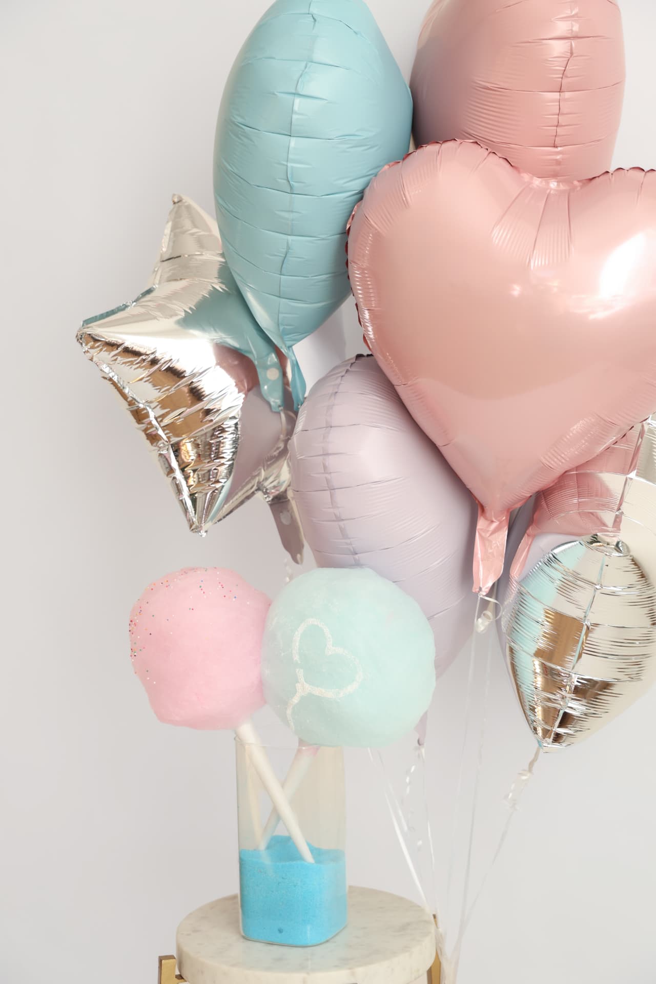 Pastel balloon bouquet with pink and blue cotton candy puffs