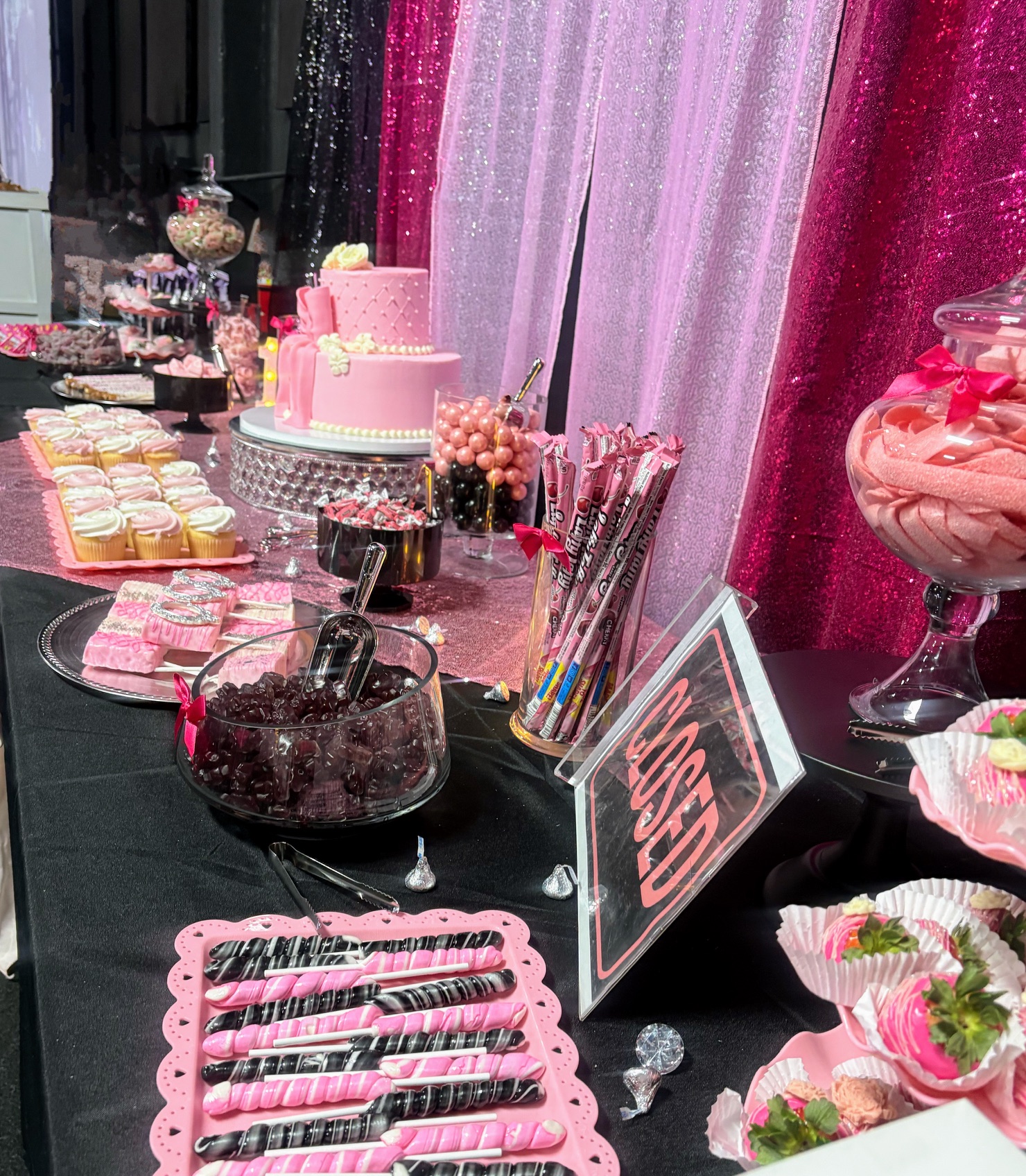 Pink candy and dessert table display with custom treats